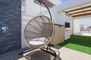 a hanging chair in a living room with a yard at Villa Melody in Protaras