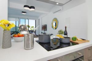 a kitchen with a counter with pots and pans on it at Villa Melody in Protaras +17 photos