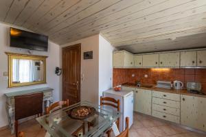 a kitchen with a table and a small kitchen with a stove at Hotel Hera in Skala Potamias