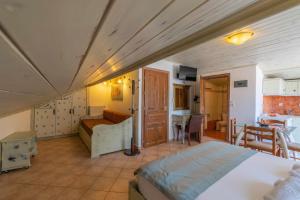 a large bedroom with a bed and a kitchen at Hotel Hera in Skala Potamias