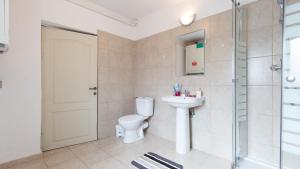a bathroom with a toilet and a sink and a shower at Nicole's Dorobanti Studio in Bucharest