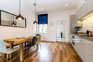 a kitchen and dining room with a wooden table and chairs at City Apartments - Priory Street in York
