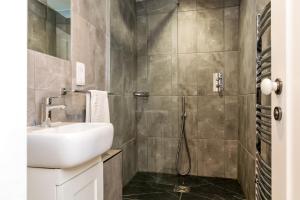 a bathroom with a sink and a shower at City Apartments - Priory Street in York +28 photos