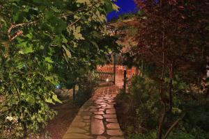a stone path in front of a house with trees at Mountain Breeze Lodge & Resort in Al Salt