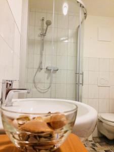 a glass bowl sitting on a counter in a bathroom at Pension SPORT-SCHMIEDE in Schmiedefeld am Rennsteig +3 photos