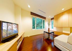 a living room with a large flat screen tv at Sun Moon Lake Karuizawa Villa in Yuchi