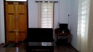 a room with a chair and a table and two doors at Family villa .hut in Tariyod