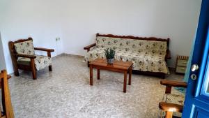 a living room with a couch and a table and chairs at Irene Double Apartment Katoi in Symi