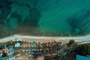 an aerial view of a beach with a group of tents at By the sea luxury suites in Limenas