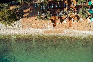 an overhead view of a beach with a body of water at By the sea luxury suites in Limenas