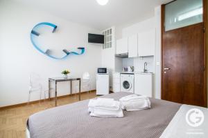 a bedroom with a bed with two towels on it at YPA APARTMENTS STORIONE in Padova