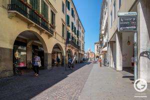 a street in a city with people walking and buildings at YPA APARTMENTS STORIONE in Padova