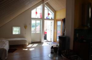 a living room with a bed and a large window at Apartment in the countryside in Tossene Hunnebostrand in Hunnebostrand