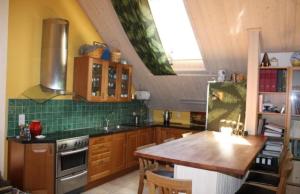 a kitchen with wooden cabinets and a wooden table at Apartment in the countryside in Tossene Hunnebostrand in Hunnebostrand