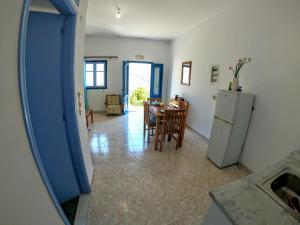a kitchen and dining room with a table and a refrigerator at Irene Double Apartment Katoi in Symi