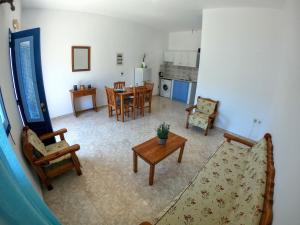 a living room with a couch and a table at Irene Double Apartment Katoi in Symi