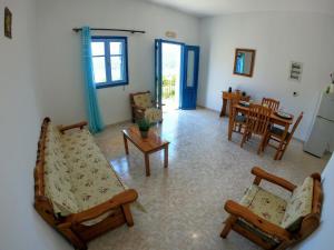 a living room with a couch and chairs and a table at Irene Double Apartment Katoi in Symi +27 photos