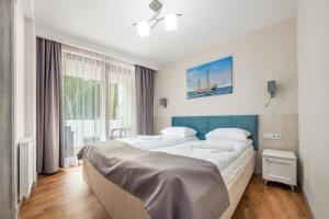 Posteľ alebo postele v izbe v ubytovaní Apartamenty Cypel Helski