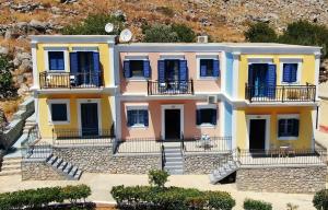 a house with yellow and pink at Irene Double Apartment Katoi in Symi