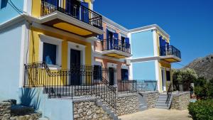 a yellow and white house with balconies and stairs at Irene Double Apartment Katoi in Symi