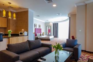 a living room with a couch and a table at Kingsgate Hotel Doha by Millennium Hotels in Doha