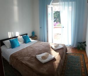 a bedroom with a large bed with towels on it at Blaga Apartment - in Korčula