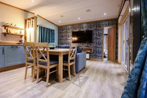 a kitchen and dining room with a table and chairs at Sandy Balls Holiday Village in Fordingbridge