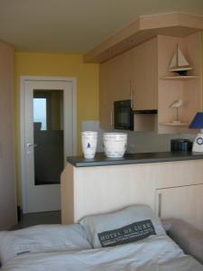 a kitchen with two white bowls on a counter at Studio apartment 'De Strandwandeling' with frontal sea view near Ostend in Ostend