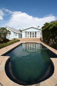 a swimming pool in front of a house at Back-Up Power with Stable WiFi! Central in Walmer in Port Elizabeth
