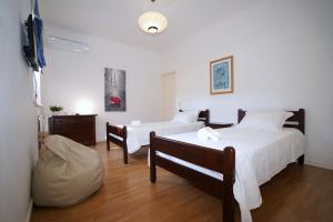 a bedroom with two beds and a tv in it at Vila Luz in Vilamoura +45 photos