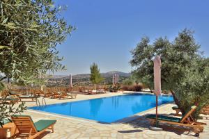 a swimming pool with chairs and a resort at Mountain Breeze Lodge & Resort in Al Salt