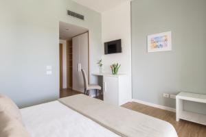 a hotel room with a bed and a television at Regiohotel Manfredi in Manfredonia