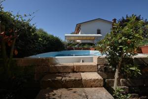 a swimming pool in the backyard of a house at Villa Ambra in Soiano del Lago
