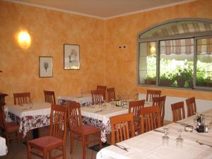 a dining room with tables and chairs and a window at Albergo Ristorante Sterlina in Grizzana