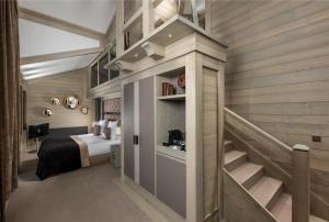 a bedroom with a bed and a staircase in it at Le K2 Djola in Courchevel