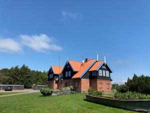 a large brick house with an orange roof at Šturmų Švyturys in Sturmai
