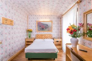 Postel nebo postele na pokoji v ubytování Albergo Italia