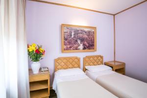 Postel nebo postele na pokoji v ubytování Albergo Italia