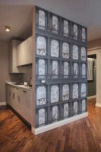 a kitchen with a wall with horses painted on it at Residenza Ducato Corte Contarina in Venice