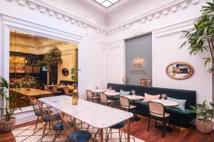 a restaurant with tables and chairs and a mirror at Mercure Nantes Centre Passage Pommeraye in Nantes