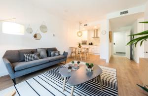 a living room with a couch and a table at Plaza de España Skyline in Madrid