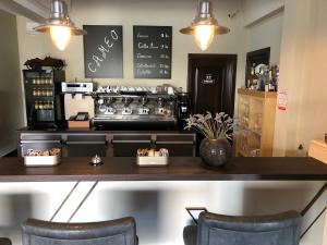 a coffee shop with a counter and two chairs at Viktoria Lodge Bed and Breakfast in Vodice