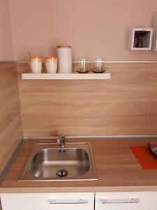 a kitchen with a sink and wooden counter top at Apartmani RALE rooms in Sarajevo +39 photos