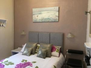 a bedroom with a bed with pillows on it at Kirkstall Guest House in Blackpool