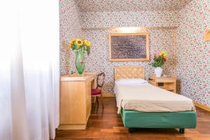 Postel nebo postele na pokoji v ubytování Albergo Italia