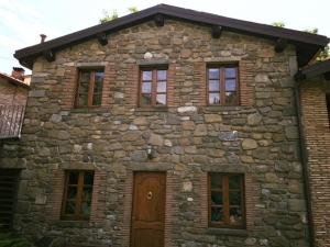CorfinoにあるHotel Panoramicoの窓と扉のある石造りの建物