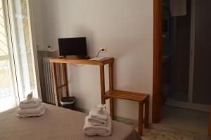 a room with a bed and a desk with a computer on it at B&B Casa di Mamma in Corato +37 photos