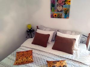 a room with a bed with pillows on it at Apartments Villa Andjela in Budva