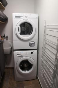 een wasmachine en een wasmachine in de badkamer bij Villa Appartement Amaryllis in Nieuwpoort