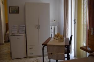 a room with a table and a large white cabinet at B&B Casa di Mamma in Corato